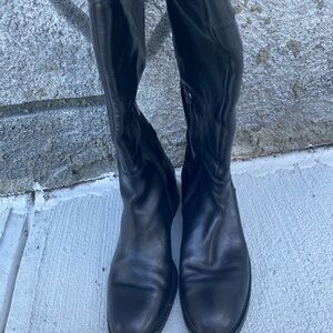 Black long boots with a half zipper on the side
